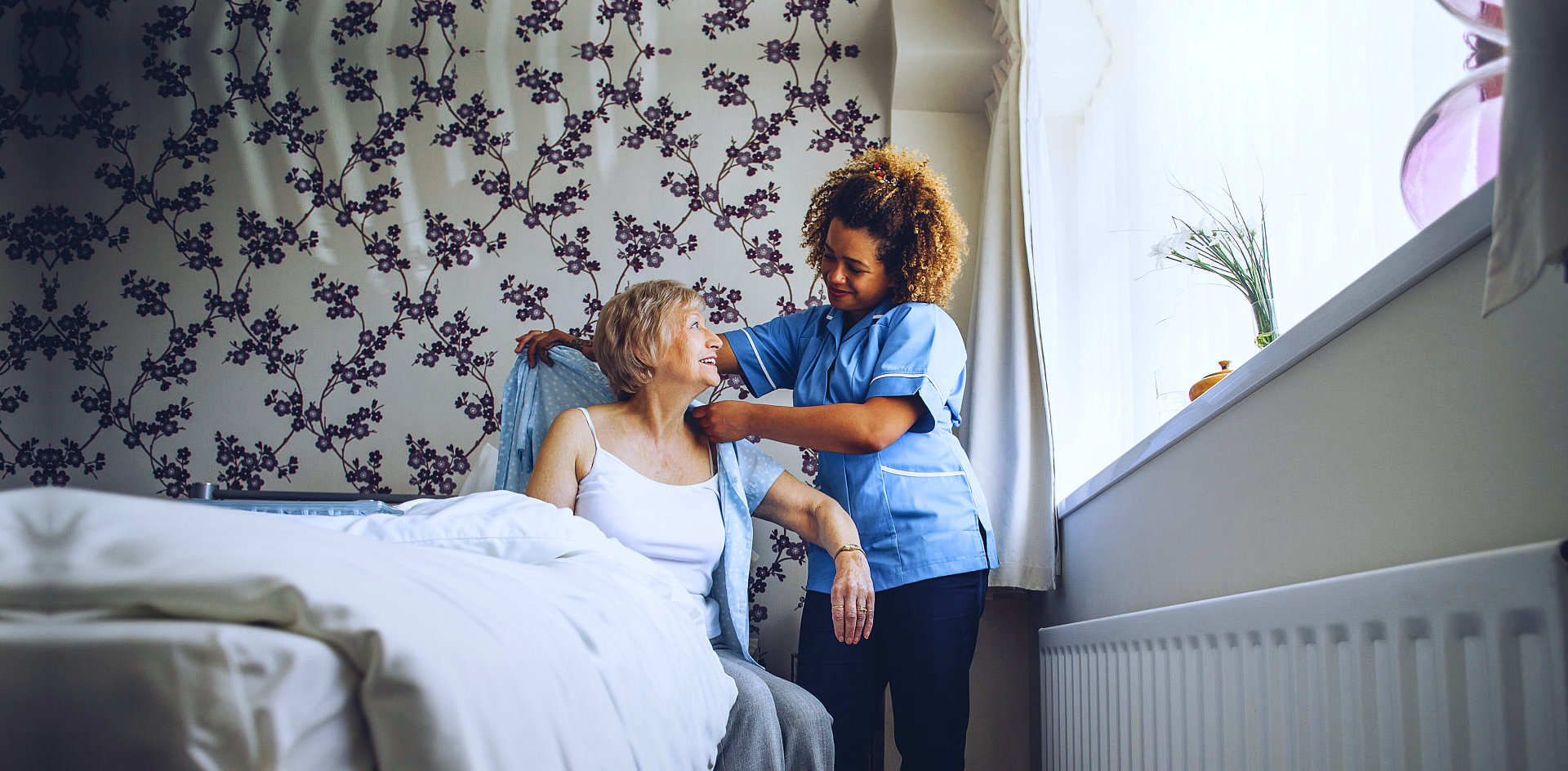 elder woman assisted by caregiver