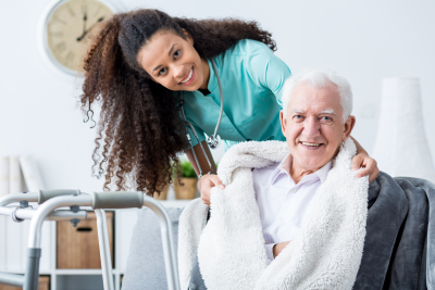 a senior man and his caregiver smiling