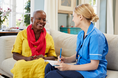 female nurse visits senior woman at home